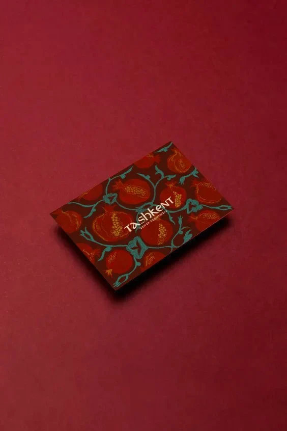 AGORA illustrated package photographed on a deep red background