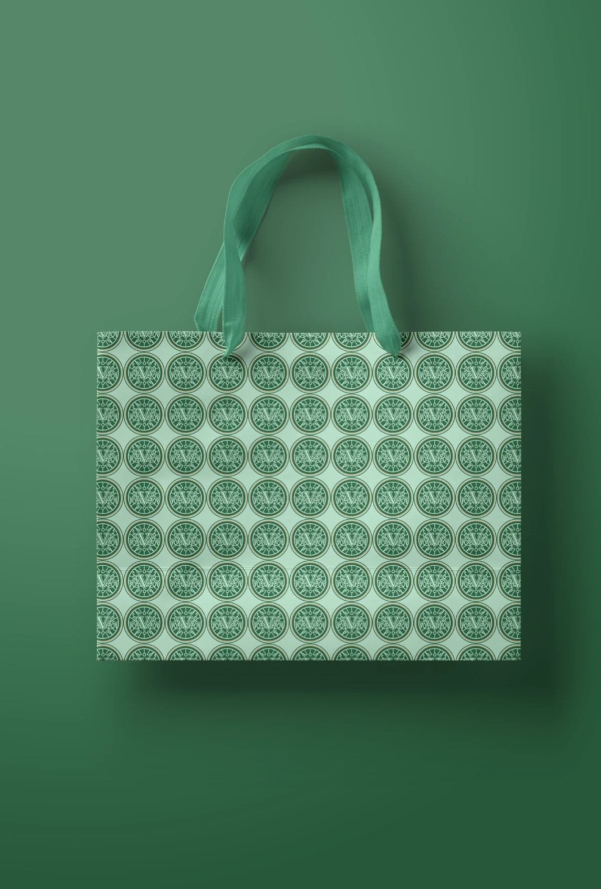 VALROY green carry bag covered in a repeating cream seal pattern